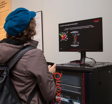 Eine Besucherin der Ausstellung "Quantensprünge" probiert Funktionen am Quantencomputer aus